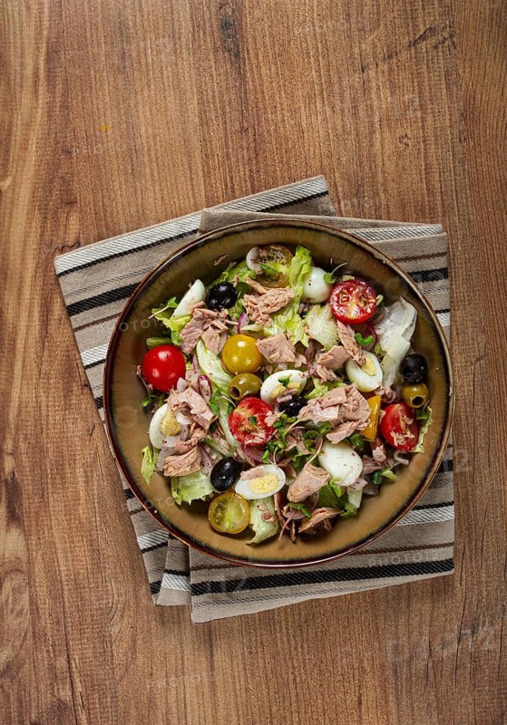 Salad with canned tuna, vegetable salad with quail eggs, lettuce, red onion, cherry tomatoes, olives, keto food, healthy food, homemade, no people