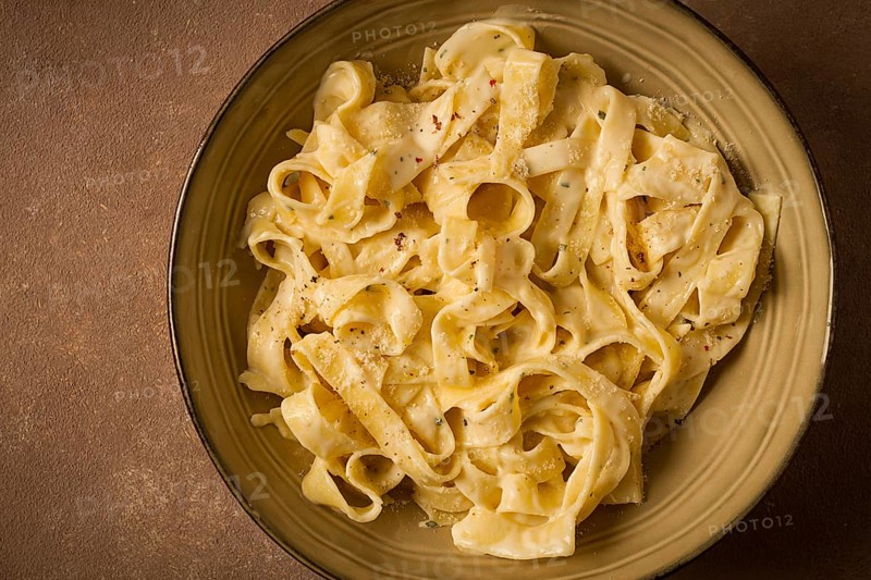 Fettuccine, tagliatelle, in creamy garlic sauce, Italian traditional cuisine, pasta carbonaro