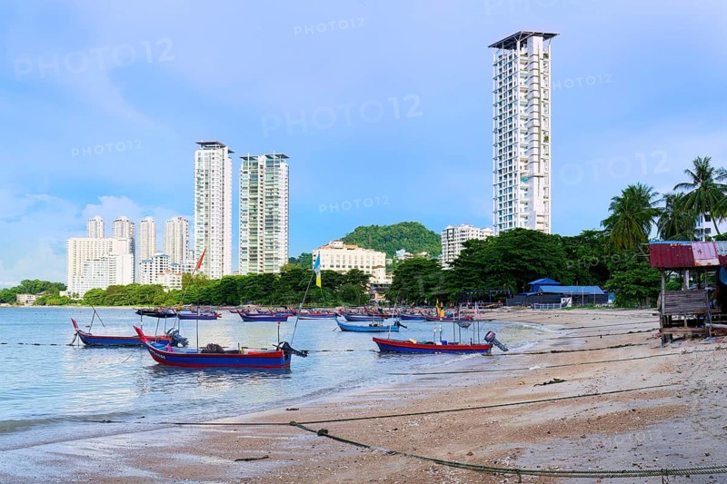 Fishing boats and George Town skyline along the Malacca Strait near Penang Floating Mosque, Penang, Malaisia