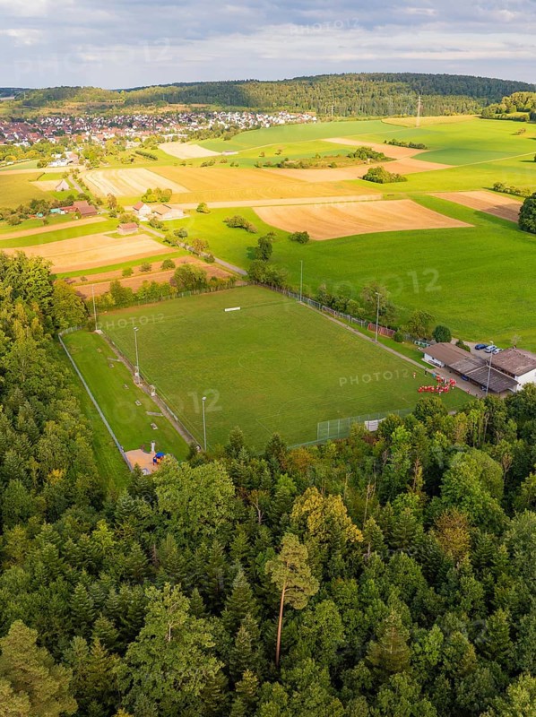 Sports ground surrounded by fields and forest near a housing estate, VFL Stammheim, Calw, Black Forest, Germany