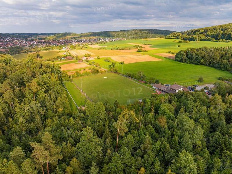 Aerial view of a rural area with a sports field surrounded by forests and fields, close to villages, VFL Stammheim, Calw, Black Forest, Germany