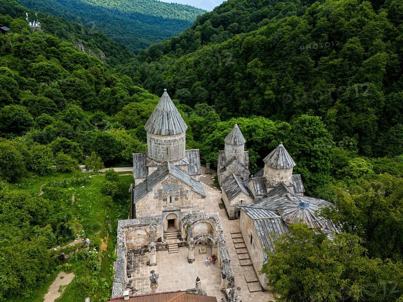 Historic monastery surrounded by dense forest and green hills, impressive stone building, aerial view, Haghartsin Monastery, Hagarzin, on the left Surp Astvatsatsin Church, on the right Surp Stepanos and Surp Grigor Church and a Gavit, Tavush Province, Armenia
