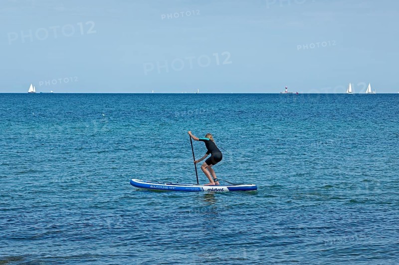 Girl stand-up paddling, Strande, Schleswig-Holstein, Germany