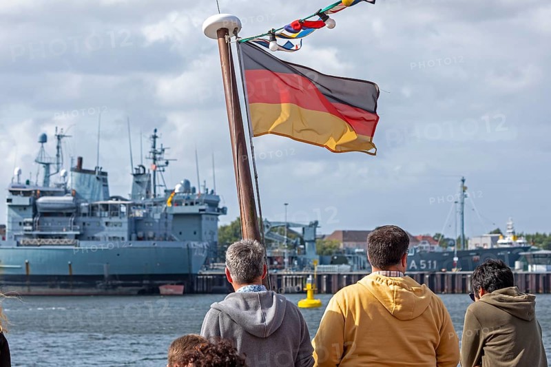 Toruists on excursion boat, flag, Bundeswehr ships, naval base, Kiel, Schleswig-Holstein, Germany