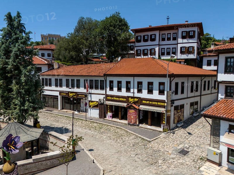 Buildings with red roofs and shops on a sunny day in a quiet, tree-lined street, aerial view, traditional Ottoman konaks, Safranbolu, UNESCO World Heritage Site, Karabük Province, Black Sea Region, Central Anatolia, Turkey