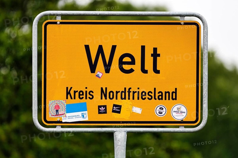 Place name sign world, inscription, many stickers, Eiderstedt peninsula, North Frisia, Germany