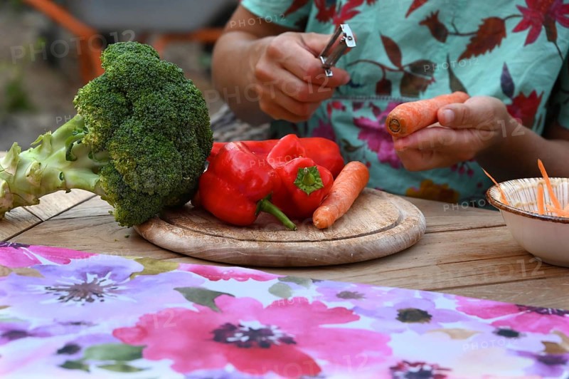 Various vegetables being prepared for a meal, carrots being peeled, Bavaria, Germany