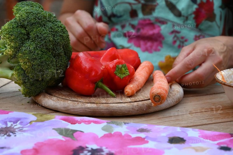 Fresh vegetables on a wooden board, broccoli, carrots and peppers, Bavaria, Germany