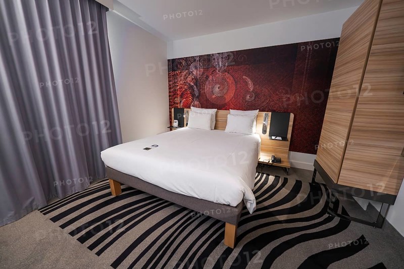 Cosy hotel room with modern design, elegant curtains and creative carpet pattern, Munich, Germany