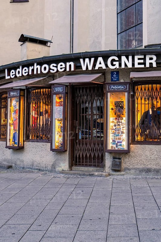 Traditional shop for lederhosen with illuminated shop window, Munich, Germany