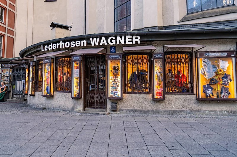 Illuminated shop window of a traditional lederhosen shop, Munich, Germany