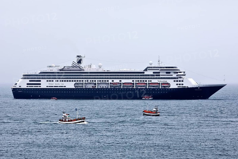 Cruise ship at sea with several small excursion boats for whale watching, Husavik, Iceland