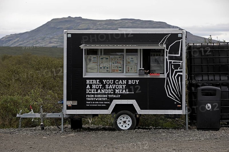 Food truck in the car park at Brúarfoss waterfall in the countryside with opening hours from 11 am to 5 pm, South Iceland, Iceland