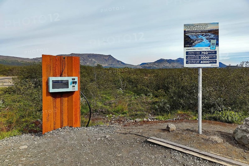 Car park at Brúarfoss waterfall with EC machines for paying in the countryside, South Iceland, Iceland