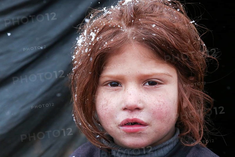 Displaced Syrian families and children living in refugee camps during harsh winter conditions, facing snow, cold weather, and difficult humanitarian circumstances. Aleppo, Syria March 13, 2022, Aleppo, Syria