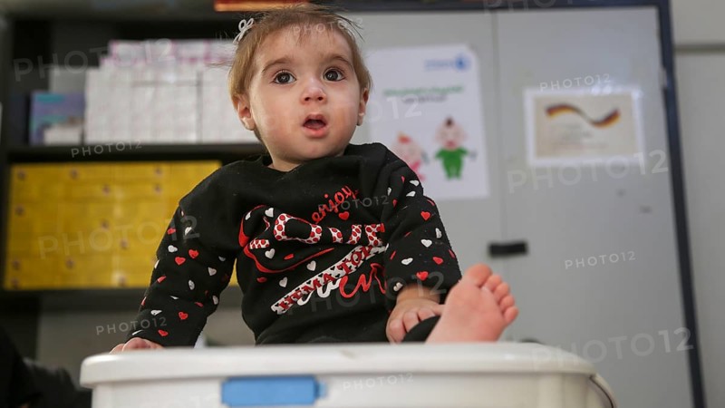 A doctor examining a refugee child for malnutrition in the camp using weight and height measurement. Aleppo, Syria October 18, 2022, Aleppo, Syria
