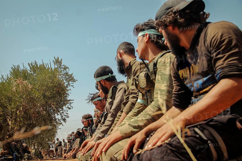 Free Syrian Army fighters praying on the battlefield during combat against terrorist organizations in northern Syria. Aleppo, Syria August 25, 2015, Aleppo, Syria