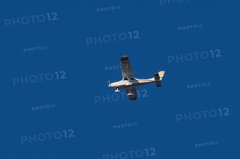 TL Ultralight Sirius 600 light aircraft flying in a blue sky, England, United Kingdom