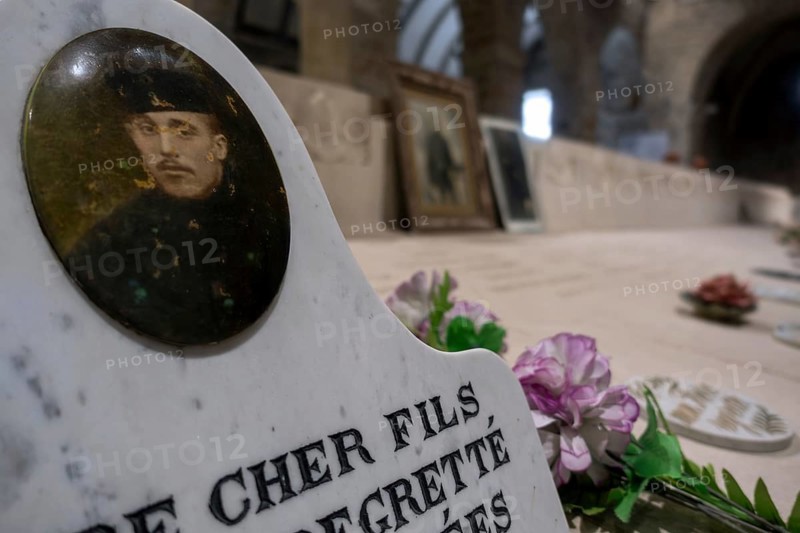 WWI soldier's portrait at necropolis with graves of Belgian World War One soldiers buried in the church of Grimde near Tienen, Tirlemont, Belgium