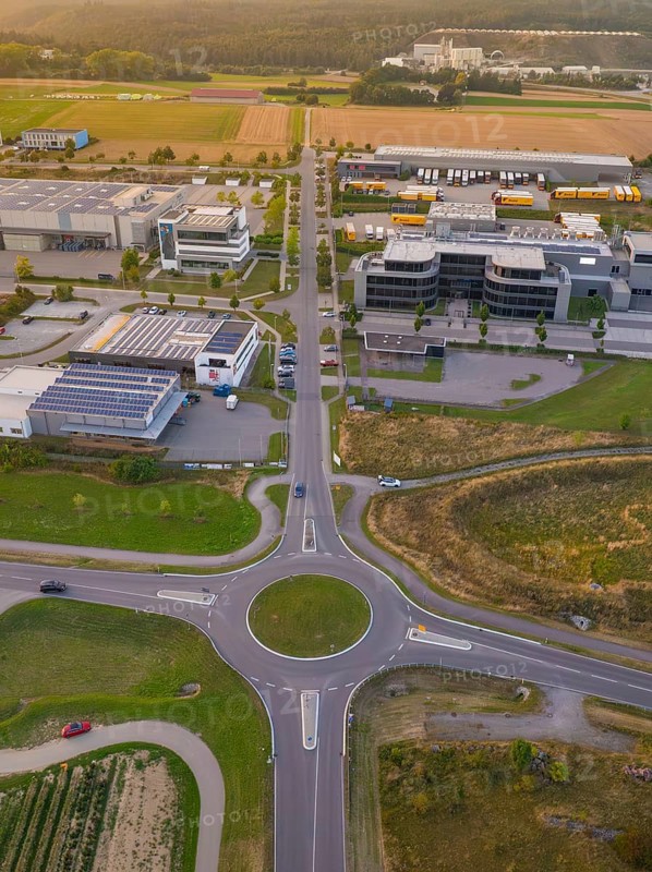 Overview of a roundabout in an industrial area, surrounded by fields and buildings, industrial area Wolfsberg Nagold, district Calw, Black Forest, Germany