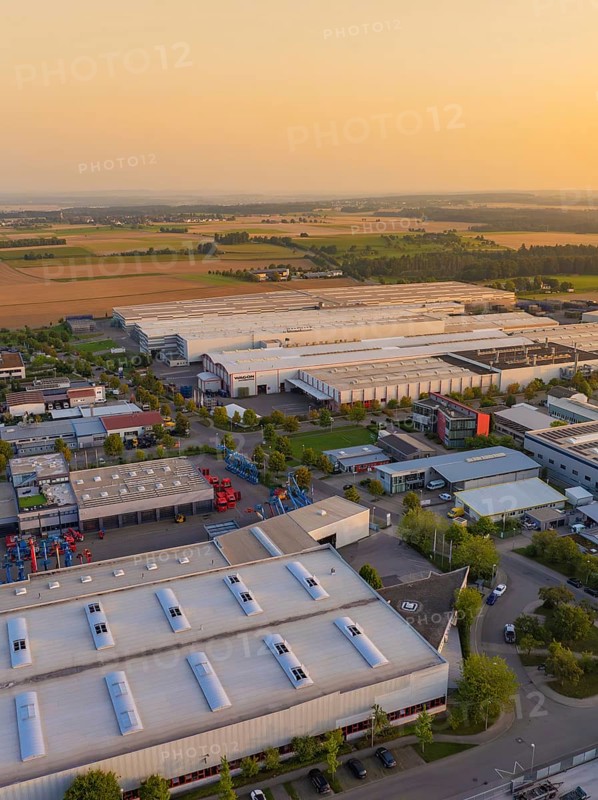 Industrial buildings and roads near fields with vehicles and urban development, Wolfsberg Nagold industrial area, Calw district, Black Forest, Germany