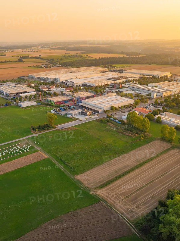 Industrial area with surrounding fields at sunset, industrial area Wolfsberg Nagold, district Calw, Black Forest, Germany
