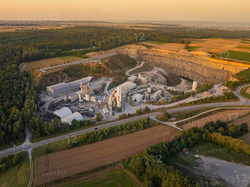 Large quarry and industrial area in a rural setting in the evening, industrial area Wolfsberg Nagold, district Calw, Black Forest, Germany