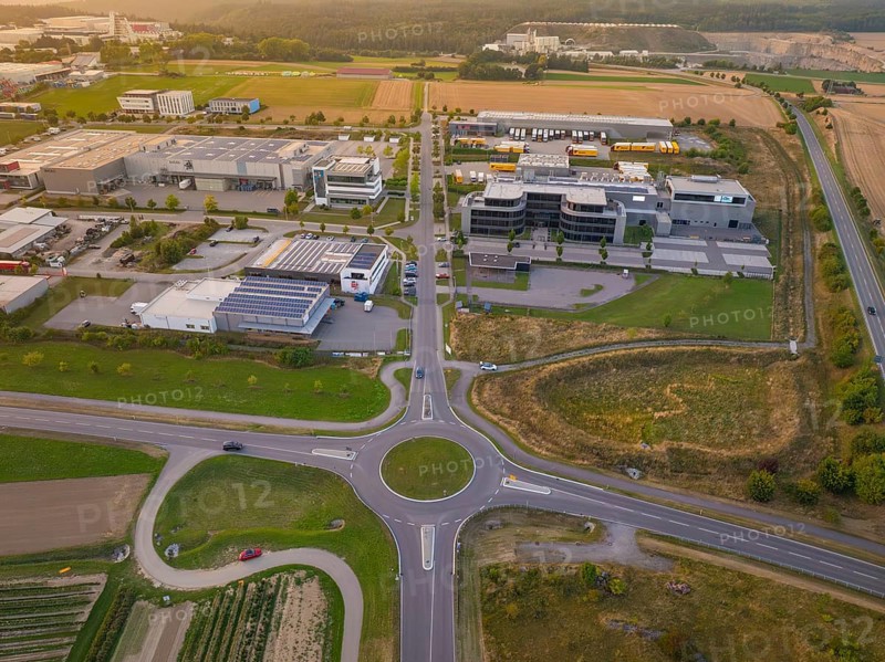 Industrial area with central roundabout, adjacent to fields and modern buildings, industrial area Wolfsberg Nagold, district of Calw, Black Forest, Germany
