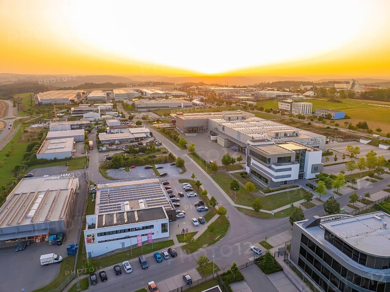 Spacious industrial estate at sunset with organised streets and modern buildings, Wolfsberg Nagold industrial area, Calw district, Black Forest, Germany