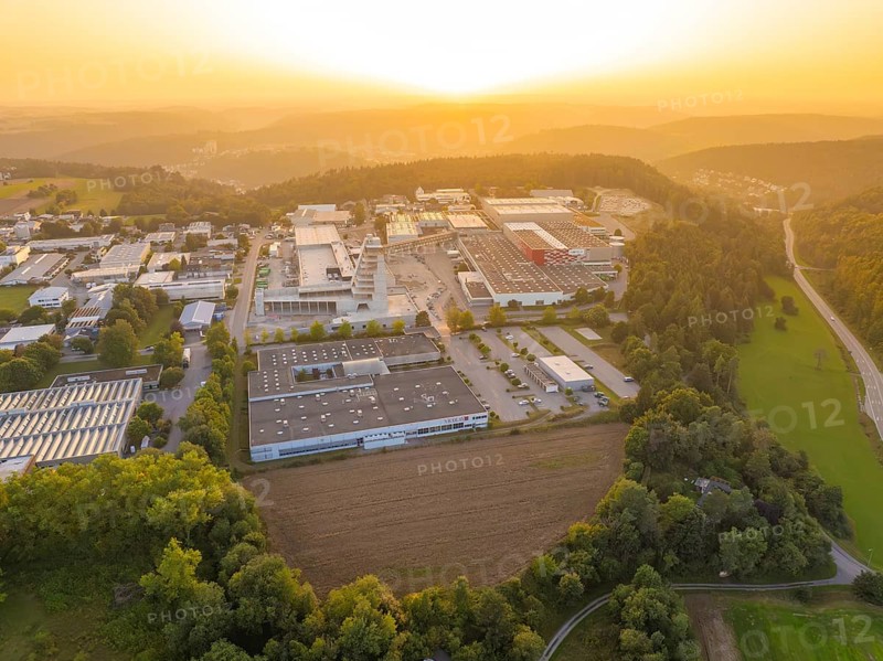 Industrial area with neighbouring forest and country road at sunset, industrial area Wolfsberg Nagold, district Calw, Black Forest, Germany