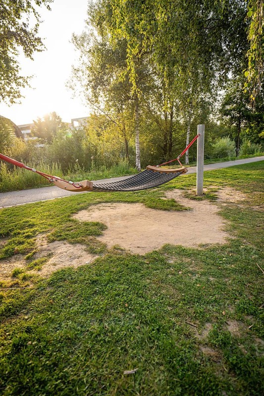 A hammock between trees in a green park at sunset, Nagold, district of Calw, Black Forest, Germany