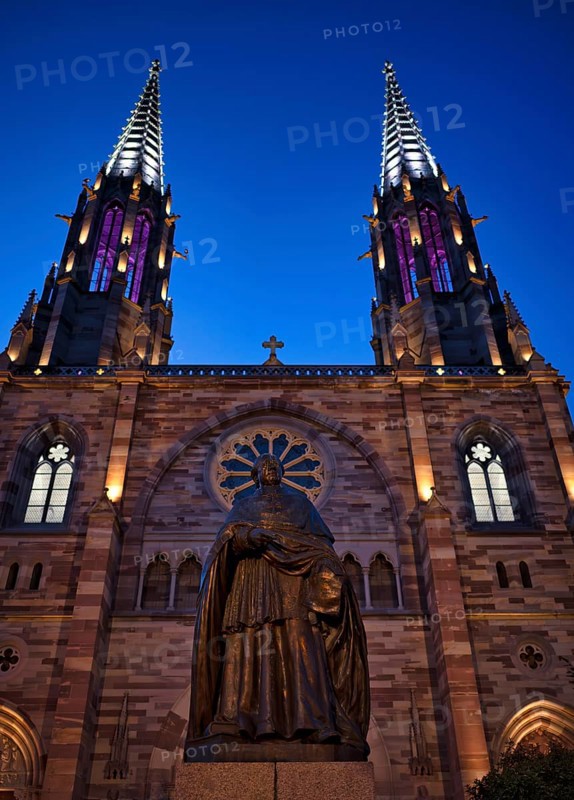 Monument, statue of Charles Emile Freppel, theologian and bishop of Angers, in front of the church Église Saints Pierre et Paul, St. Peter et St. Paul, old town, Obernai, also Oberehnheim, blue hour, dusk, Bas-Rhin, Grand-Est, Alsace, France