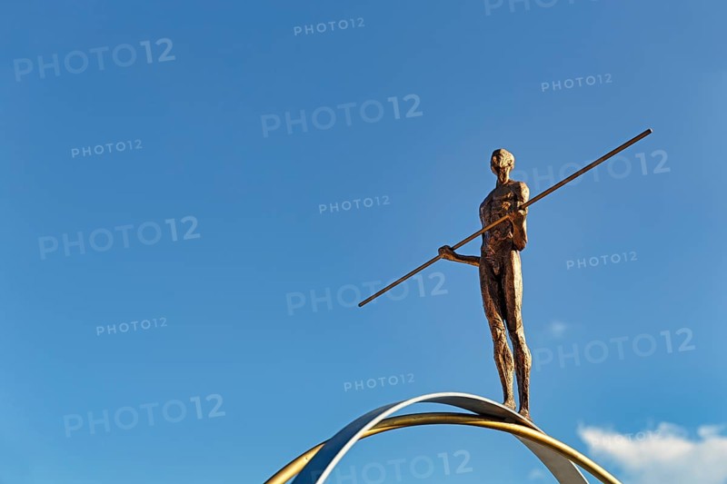 Sculpture Balance by the artist Martina Ondáková in front of a blue sky, human figure balanced, symbolic image, striving for balance and harmony, Oia, Thira, Santorini, Cyclades, Greece