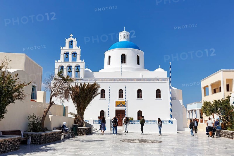 Orthodox church Panagia Platsani, whitewashed, typical blue dome, pyramid-shaped bell tower with six bells, central square in the old town, Oia, Thira, Santorini, Cyclades, Greece