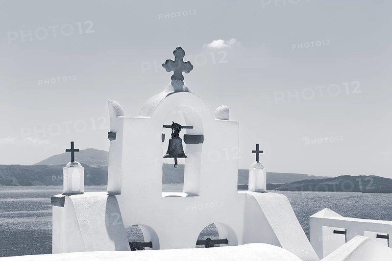 White bell tower of an orthodox church by the sea, monochrome, Oia, Thira, Santorini, Cyclades, Greece