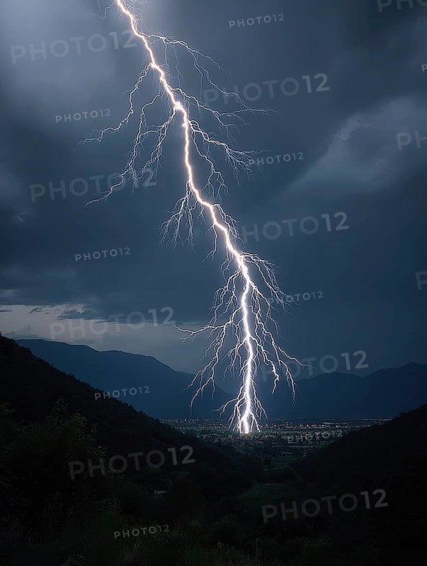 A large flash of lightning illuminates the night sky over a landscape surrounded by mountains, AI generated, AI generated