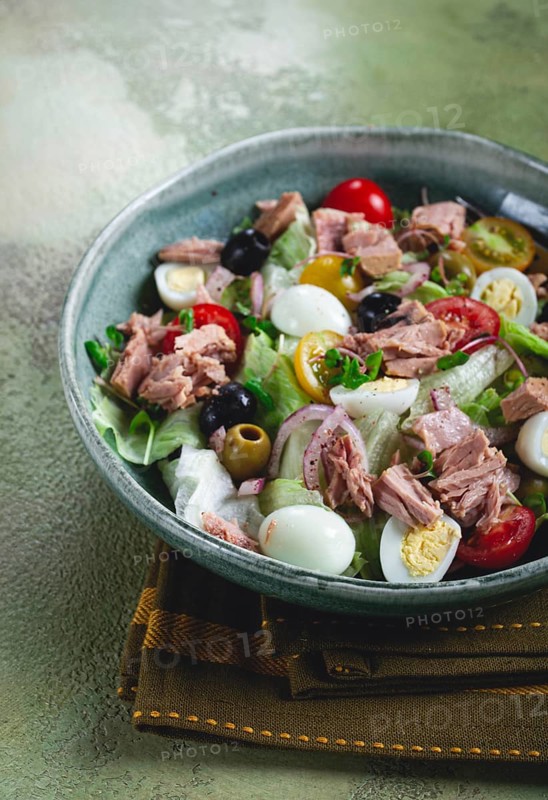 Salad with canned tuna, vegetable salad with quail eggs, lettuce, red onion, cherry tomatoes, olives, keto food, healthy food, homemade, no people