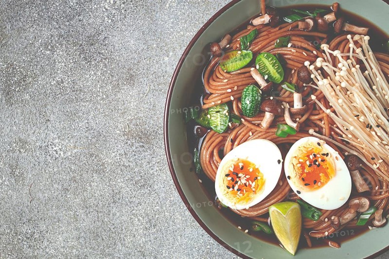 Soba, buckwheat noodles, with enoki mushrooms, shimeji and boiled egg, top view, homemade, no people