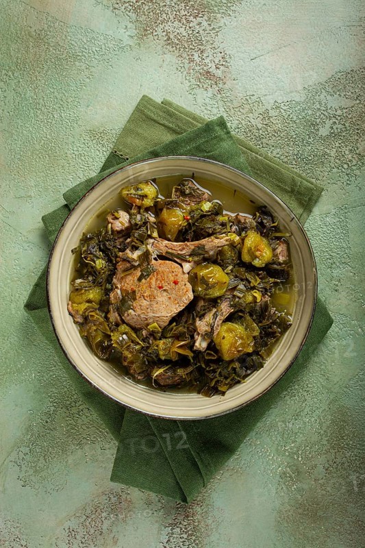 Chakapuli, Georgian dish, stewed meat with herbs and tkemali, in white wine, homemade, no people