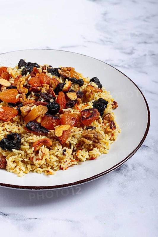 Rice dish, with the addition of dried fruits, nuts and spices of Middle Eastern cuisine, homemade, no people