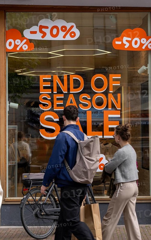 Fashion shop, boutique, with advertisement in the window for the end of season sale, summer sale, Groningen, Netherlands