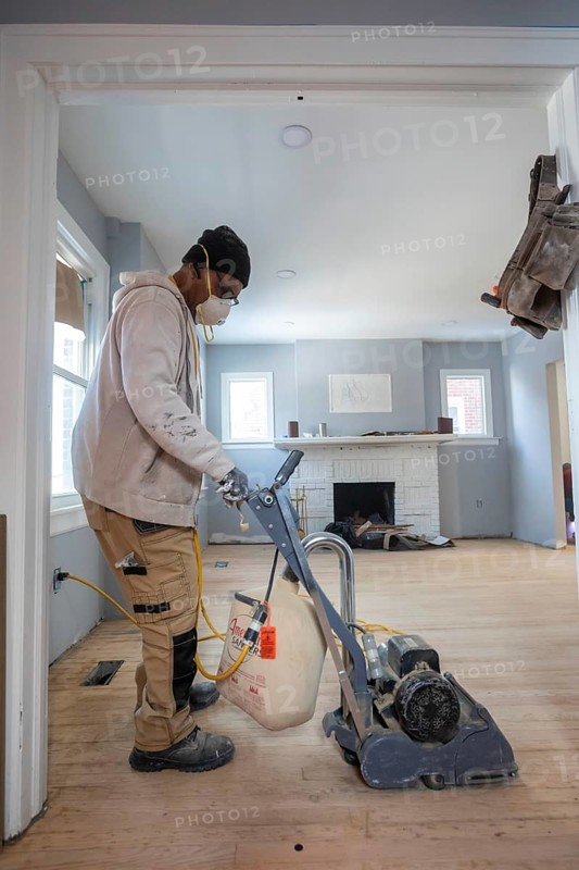 Detroit, Michigan - Workers sand a floor as they remodel a house in the Morningside neighborhood. The house had been vacant for many years. Detroit lost nearly two-thirds of its residents from 1950 to 2020 but has been growing modestly in recent years