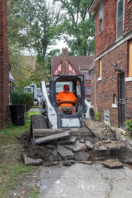 Detroit, Michigan - Workers replace an old driveway, part of remodeling a house in the Morningside neighborhood that had been vacant for many years. Detroit lost nearly two-thirds of its residents from 1950 to 2020 but has been growing modestly in recent years