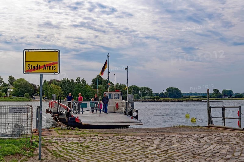Ferry across the Schlei and town sign at the pier of Arnis, the smallest town in Germany. Arnis, Schleswig-Holstein, Germany