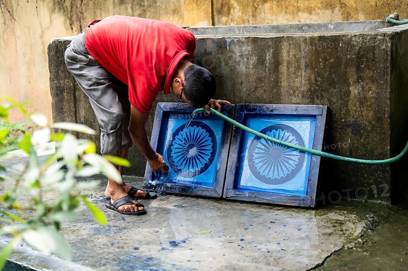 Employee of the Assam Khadi and Village Industries Board cleaning Ashoka Stambh screen printing block in a manufacturing unit of Indian National Flag, ahead of 79th Independence Day, in Guwahati, India on 11 August 2025