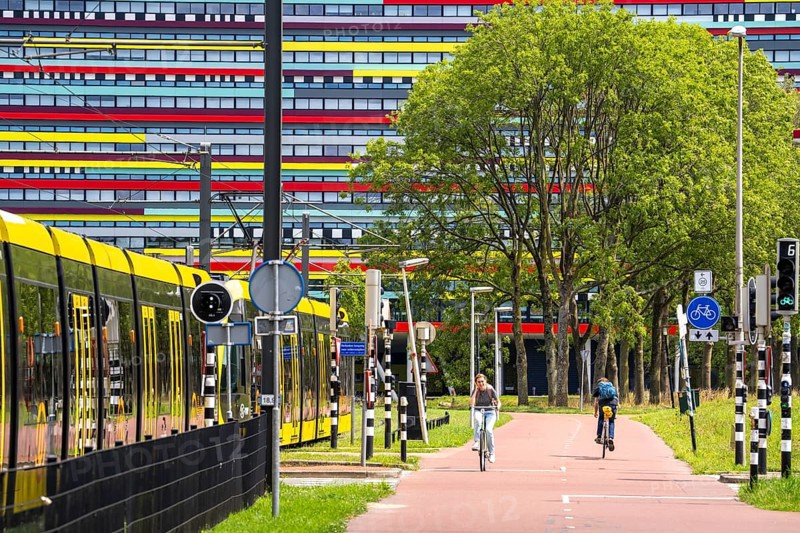 Cycle path through the university campus in Utrecht Science Park, Utrecht University, colourful facade of the Hogeschool Utrecht building, public transport, tram, Netherlands
