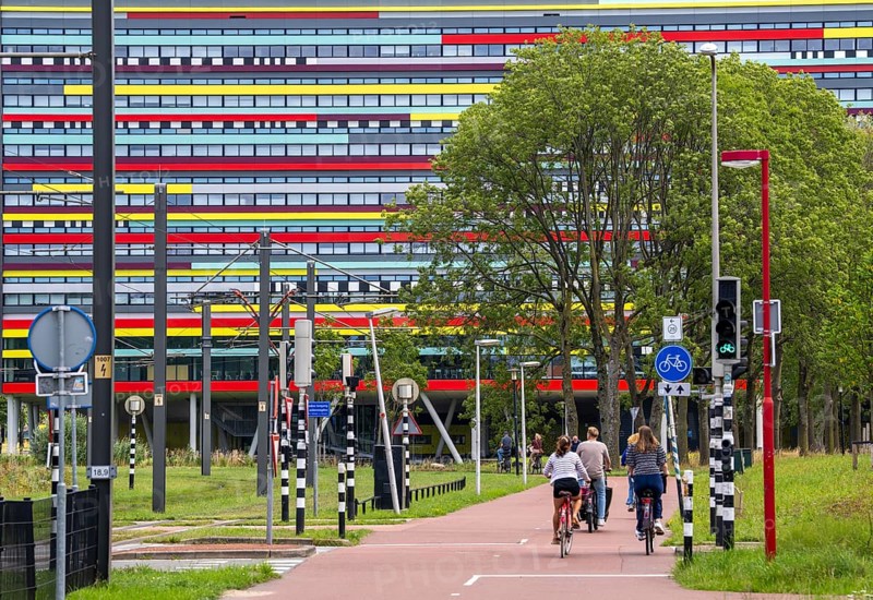Cycle path through the university campus in Utrecht Science Park, Utrecht University, colourful facade of the Hogeschool Utrecht building, Netherlands