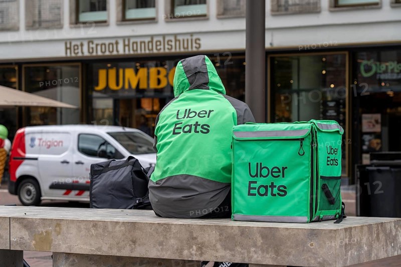 Bicycle transport in Groningen, Uber Eats, courier driver waiting for new orders, Netherlands