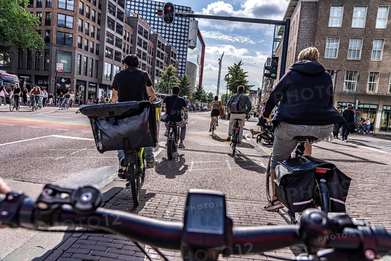 Ride your bike on the central cycle path on Lange Viestraat, Vredenburg, in the city centre of Utrecht, lanes for pedestrians, cyclists and public transport vehicles are separated, heavy cycle traffic, Netherlands