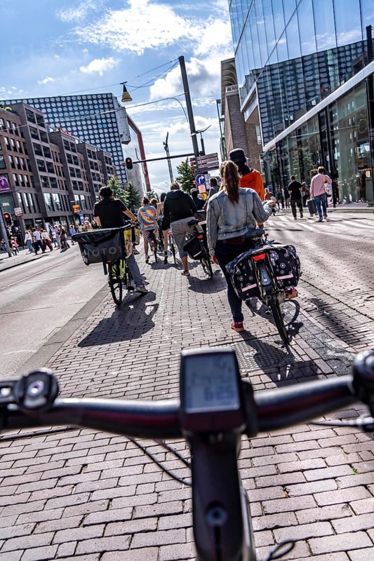Ride your bike on the central cycle path on Lange Viestraat, Vredenburg, in the city centre of Utrecht, lanes for pedestrians, cyclists and public transport vehicles are separated, heavy cycle traffic, Netherlands